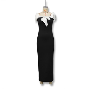 Detail of elegant black and white bodycon dress with a large white bow on the neckline