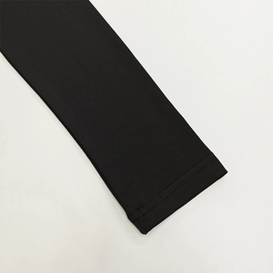 Close-up of double-needle stitching and high-quality elastic knit fabric on black dress