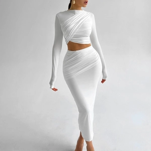 Detailed view of white two-piece set featuring ruched cropped top and fitted maxi skirt