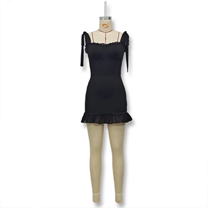 Detail of black slim dress with ruffle trim neckline and adjustable bow straps