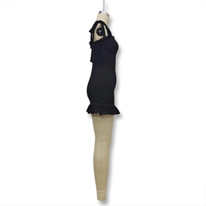 Detail of slim fit black dress showing side silhouette and bow tied shoulder straps