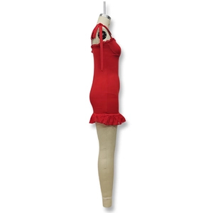 Detail view of red slim fit mini dress with bow shoulder straps and ruffled hem design