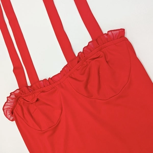 Detail shot of the ruffled neckline and wide straps on this red slim-fit dress