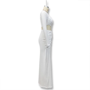 Side view of white two-piece set featuring cropped long sleeve top and maxi skirt detail