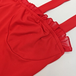 Detail of red slim fit mini dress showing ruffled neckline and thin shoulder straps