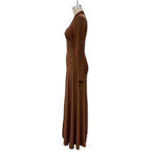 Détail du décolleté en V profond et du plissé raffiné sur une robe longue marron café