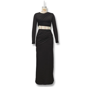 Close-up of ruched texture on black long-sleeve crop top and high waist maxi skirt set