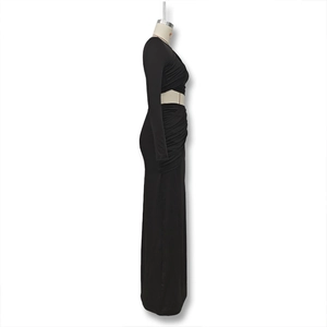 Detail of the twisted crop top hem and high waist skirt seam on black two-piece set