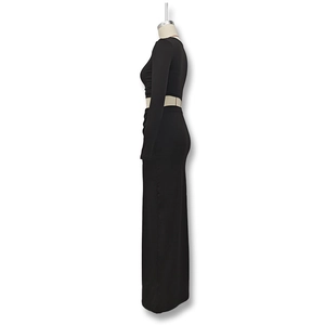 Side view of black two-piece set featuring a cropped long sleeve top and a slim maxi skirt