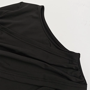 Close-up of pleated black fabric showing high-quality stitching and elastic texture