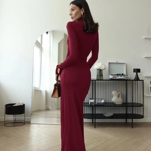 Detail of burgundy turtleneck bodycon dress showing the premium ribbed knit fabric texture
