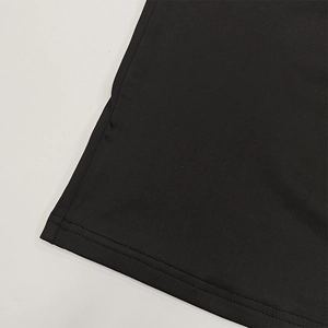 Close-up detail of double-needle stitching on black slim fit long sleeve crop top hemline