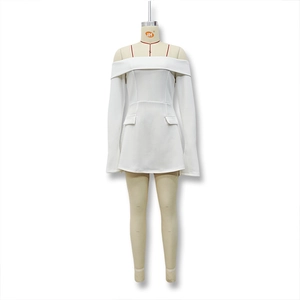 Detailed view of white off-the-shoulder mini dress with long sleeves and decorative pockets