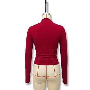 Detailed back view of a slim-fit dark red turtleneck top on a mannequin stand