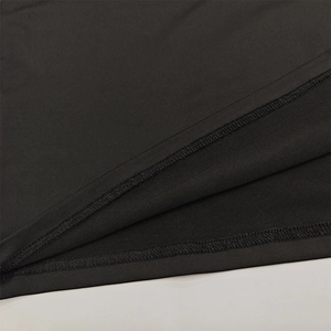 Detailed close-up showing the fine knit fabric and double-needle stitching of the black skirt