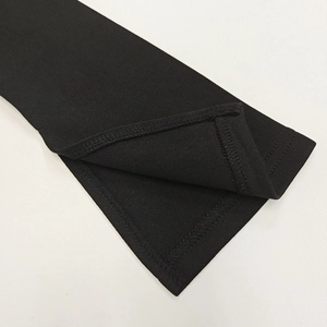 Detail of clean stitching and inner hem on black off-shoulder long sleeve dress