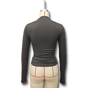 Close-up back view of dark grey slim fit turtleneck sweater with fine knit texture