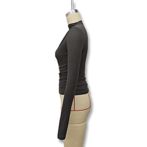 Detail view of high-elasticity knit fabric and side pleat design on this slim fit turtleneck