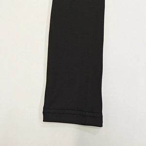 Detail of double-needle reinforced stitching on black high-stretch fabric sleeve cuff