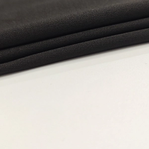 Close-up of premium black knitted fabric texture with fine granular weave pattern