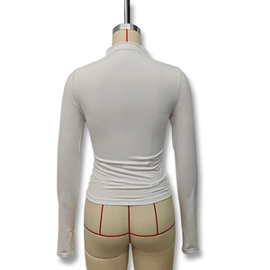 Detail view of white long sleeve turtleneck top back with elastic pleated fabric