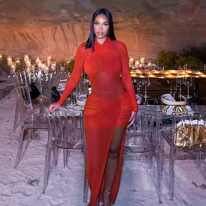 Detailed view of the red mesh dress featuring a criss-cross halter neck and sheer cutout design