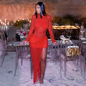 Detail of red mesh dress showing criss-cross halter neckline and pleated sheer fabric texture