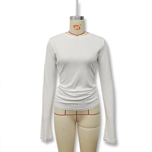 Close-up of slim fit white crew neck top showing the ribbed cotton fabric and stitching