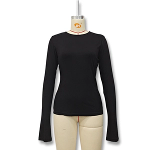 Detail of slim fit black long sleeve top with crew neck on a female mannequin
