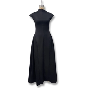 Detail of elegant black sleeveless A-line maxi dress with mock neck on mannequin