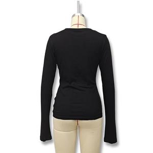 Slim fit black long sleeve t-shirt with crew neck and thumbhole cuffs on a mannequin