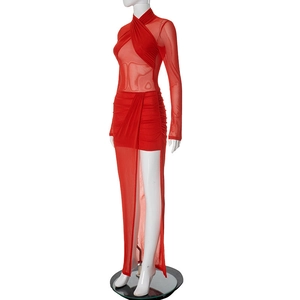 Detail showing the red sheer mesh fabric and crossover halter neckline of the mini dress