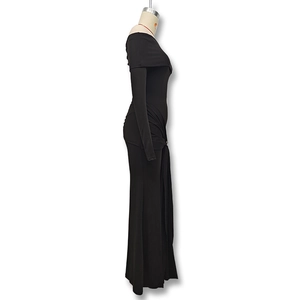 Detail of elegant black off-shoulder maxi dress with side ruched texture and slim fit