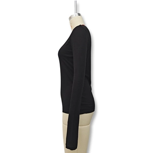 Side view detail of slim fit black long sleeve top with elegant flare cuffs
