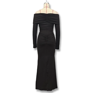 Detail of elegant black off-shoulder maxi dress featuring ruching on back and hips