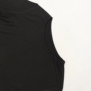 Close-up of the smooth black knit fabric texture and armhole seam stitching detail