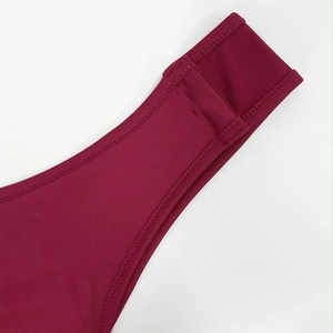 Detailed close-up showing reinforced double stitching and elastic fabric of the burgundy dress