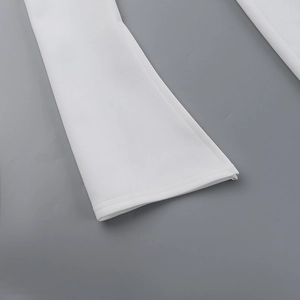 Macro shot of white flared pants hem showing high-density fabric and professional stitching