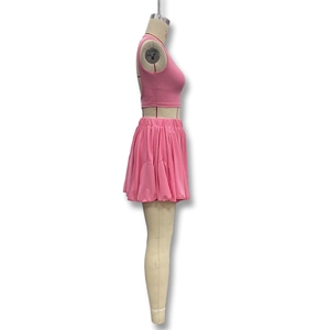 Detail view of pink sleeveless crop top and pleated mini skirt set on a mannequin