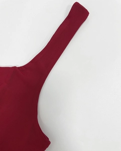 Detailed close-up of dark red mesh fabric and smooth stitching on the strap