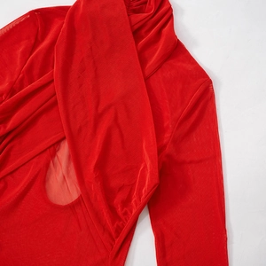 Detailed view of red mesh fabric showing cross-stitch texture and semi-transparent layers