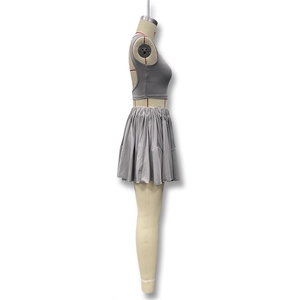 Detail of grey two-piece set featuring backless crop top and high waist pleated skirt