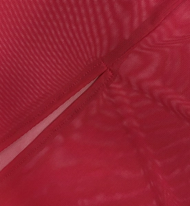Detailed close-up of dark red mesh fabric with stitching for long sexy dress