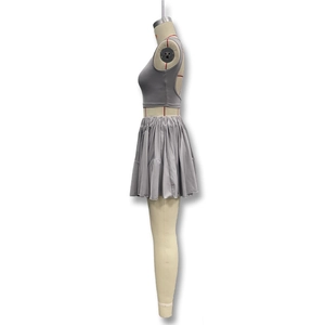 Detail view of the gray backless crop top and pleated mini skirt showing the side profile