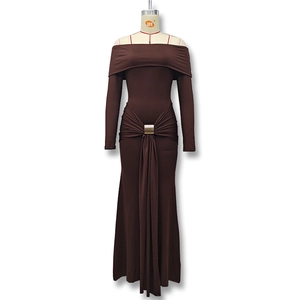 Detail showing the gold circular buckle and elegant side draping on a brown dress