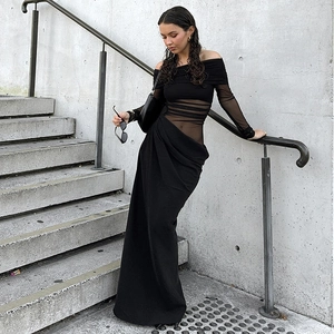 Detail of off-shoulder black dress showing sheer mesh panel and pleated waist texture