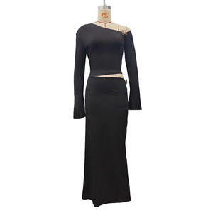 Detail of black one-shoulder long sleeve top and slim long skirt on a mannequin