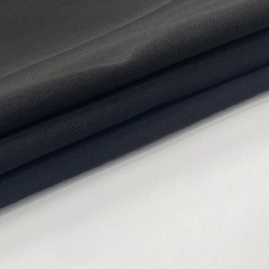 Close-up of premium black knitted fabric showing soft texture and high-quality material layers