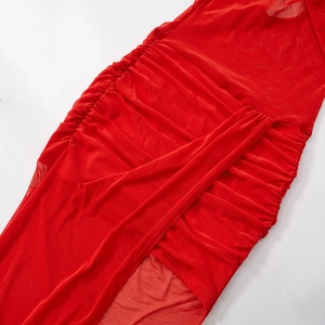 Detail of red mesh bodycon dress featuring elegant side ruching and thigh-high side slit