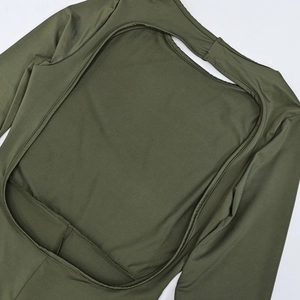Detail view of dark green slim fit jumpsuit featuring a backless cutout and long sleeves